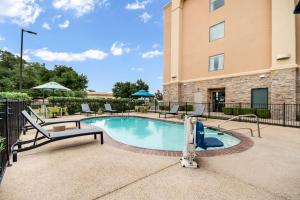 a swimming pool with a slide in front of a building at Hampton Inn Uvalde in Uvalde