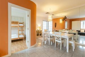 a dining room and living room with a table and chairs at Casa do Rio in Chaves