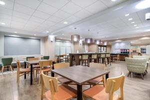 a restaurant with tables and chairs and a chalkboard at Hampton Inn Uvalde in Uvalde
