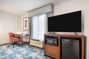 a hotel room with a large flat screen tv at Hampton Inn Uvalde in Uvalde