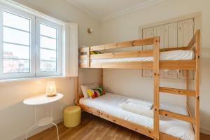a room with two bunk beds and a desk at Casa do Rio in Chaves