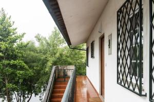 a staircase leading up to a house with a window at Casa do Rio in Chaves