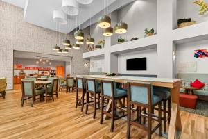 a dining room with a bar and chairs at Hampton Inn & Suites El Paso West in Borderland