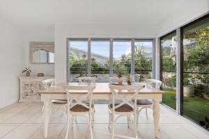 a dining room with a table and chairs at Tallows Coastal Retreat in Kingscliff