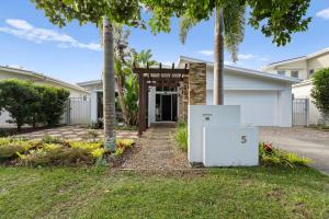 a house with a generator in the front yard at Tallows Coastal Retreat in Kingscliff
