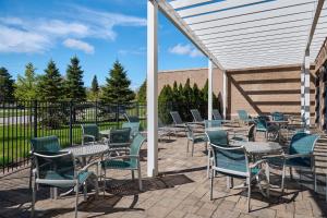 a group of chairs and tables and chairs on a patio at Hampton Inn & Suites Detroit/Troy in Clawson