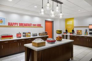 a fast food restaurant with a happy breakfast line at Hampton Inn & Suites Detroit/Troy in Clawson