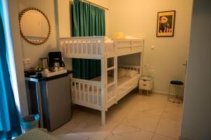 a room with two bunk beds and a mirror at MANI HOLIDAYS Rooms in Neo Itilo +7 photos