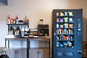 a blue refrigerator freezer next to a table with food at Travelodge by Wyndham Worland in Worland