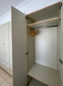 a walk in closet with white cabinets and a ceiling at Pnoe Home in Kavála +17 photos
