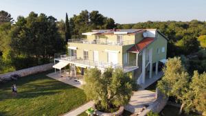 an aerial view of a house with a garden at Apartments Nogic in Peroj