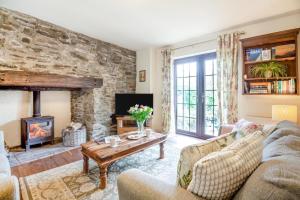 a living room with a couch and a fireplace at 2 Bed in Carmel oc-wai210 in Llanerchymedd