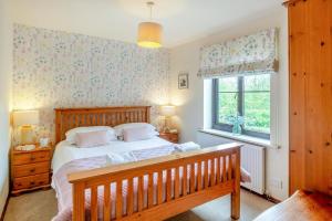 a bedroom with a bed and a window at 2 Bed in Carmel oc-wai210 in Llanerchymedd
