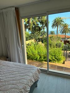 a bedroom with a bed and a large sliding glass door at Villa Naussica in Saint-Raphaël +121 photos