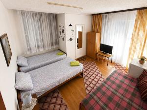 a living room with two beds and a television at Villa Flora in Ohrid