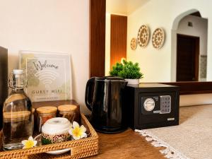 a kitchen counter with a coffee maker and a microwave at Purnama House Ubud in Ubud