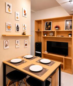 a dining room with a table and a tv at Stylish 2BR Near Food - Shops-Fast WiFi-Late Checkin in Gedong +20 photos