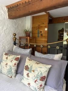 a bedroom with a bed with pillows on it at Maison SItta in Montferrier +2 photos