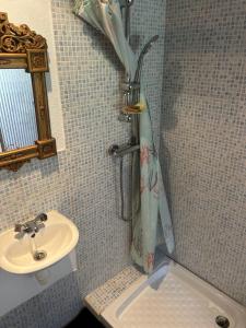 a bathroom with a sink and a shower curtain at Maison SItta in Montferrier