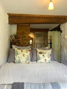 a bedroom with a large bed with a wooden headboard at Maison SItta in Montferrier