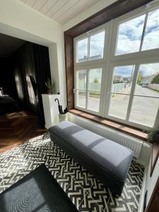 a living room with a bench in front of a window at Roslep Apartment in Haapsalu