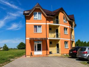 a orange building with cars parked in front of it at Hotel Doina 1 Tășnad in Tăşnad +12 photos