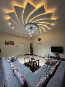 a living room with a couch and a ceiling at Aloche Apartments in Murree