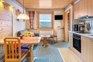 a small kitchen and dining room with a table and chairs at Haus Schmid in Lenzkirch