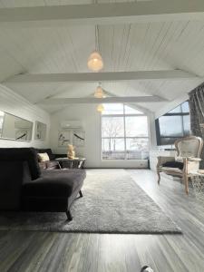 a large living room with a couch and a table at Brightside House in Kristiansand