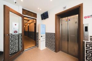 a hallway with two elevators in a building at Seoul101 Jongno in Seoul
