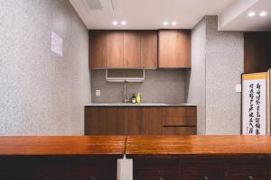 a kitchen with wooden cabinets and a counter top at Seoul101 Jongno in Seoul +18 photos
