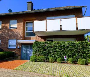 a brick house with a blue door at Apartment37671 in Höxter