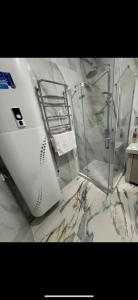 a bathroom with a shower and a sink at Ametist in Mukacheve