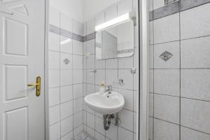 a white bathroom with a sink and a mirror at Sivotahomes - Noah in Syvota +118 photos