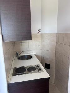 a small kitchen with a sink and a stove at Apartment Zekija in Barbat na Rabu +47 photos