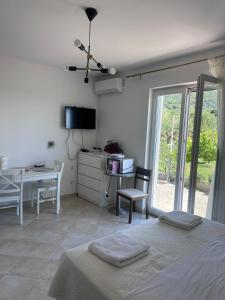 a bedroom with a bed and a table and a desk at Apartment Zekija in Barbat na Rabu