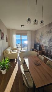 a living room with a table and a couch at Damisa Lux Stan in Tivat