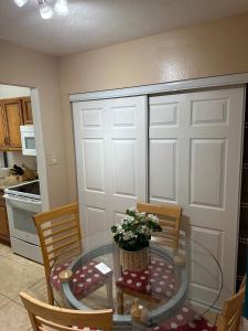 a kitchen with a table and chairs and a door at A cozy room with double bed in semi shared Flat in Wallisellen