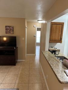 a kitchen with a sink and a counter top at A cozy room with double bed in semi shared Flat in Wallisellen