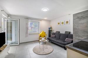 a living room with a couch and a table at Leicht in Münsingen