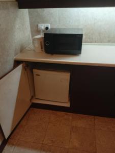 a microwave sitting on top of a kitchen counter at Imperial resident time Square KL in Kuala Lumpur