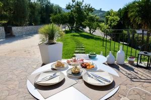 a white table with plates of food on it at B&B Borgo del Nespolo in Peschici