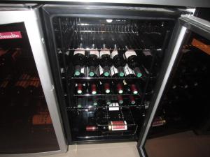 a refrigerator filled with lots of bottles of wine at Villa Margaux Opéra Montmartre in Paris