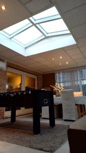 a skylight in a room with a table and chairs at Julie's Place in Westerlo