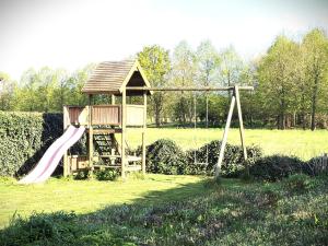 a playground with a slide in a field at Julie's Place in Westerlo