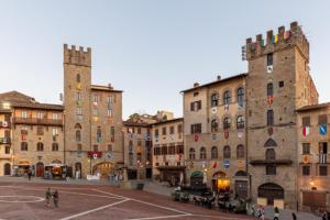 a group of buildings with people walking around a street at Casa Mafalda, Piazza Grande in Arezzo