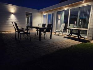 a table and chairs on a patio at night at Julie's Place in Westerlo