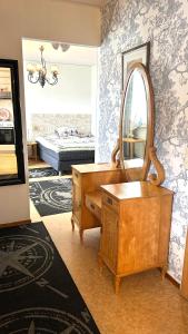 a room with a vanity and a mirror and a bed at Peaceful studio with sauna in Liperi