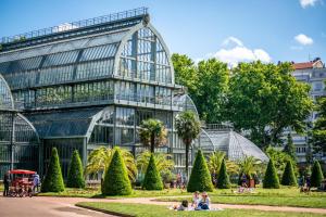a large glass building with people sitting in front of it at 2 ch, climatisé, parking, localisation premium in Lyon