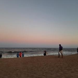 a group of people standing on a beach at Koovathur Ecr beach house in Kūvattūr